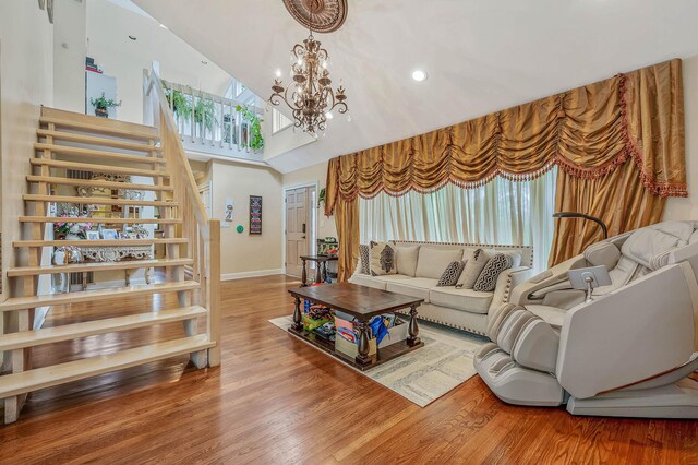 2 Farmview Dr, Dix Hills, NY 11746 - living room with stairway, a chandelier, high vaulted ceiling, wood finished floors, and baseboards