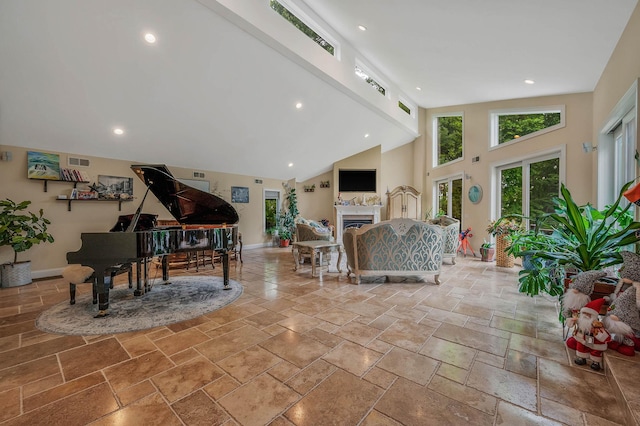 2 Farmview Dr, Dix Hills, NY 11746 - living room featuring high vaulted ceiling, stone tile floors, baseboards, recessed lighting, and a fireplace