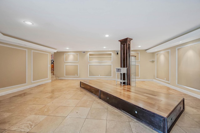 2 Farmview Dr, Dix Hills, NY 11746 - unfurnished living room with ornate columns, recessed lighting, light tile patterned floors, a decorative wall, and baseboards