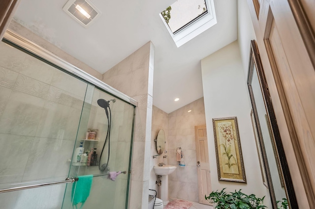 2 Farmview Dr, Dix Hills, NY 11746 - bathroom featuring lofted ceiling, a stall shower, tile walls, a skylight, and toilet