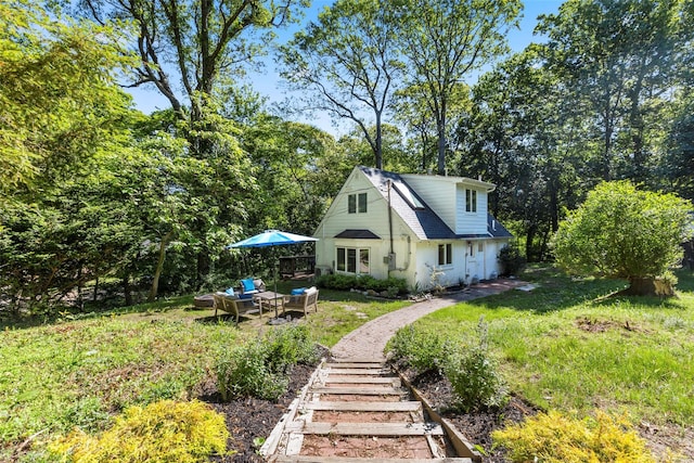 51/2 Locust Ave, Stony Brook, NY 11790 - back of property with an outdoor hangout area and a lawn
