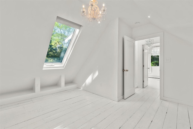 51/2 Locust Ave, Stony Brook, NY 11790 - interior space with a chandelier, a skylight, lofted ceiling, and light wood-style floors