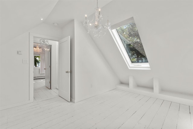 51/2 Locust Ave, Stony Brook, NY 11790 - bonus room featuring a chandelier, a skylight, baseboard heating, vaulted ceiling, and wood finished floors