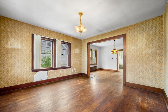 16 Oak Ter, Suffern, NY 10901 - unfurnished room with wallpapered walls, wood-type flooring, baseboards, a chandelier, and radiator