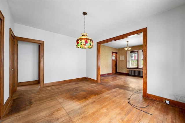 16 Oak Ter, Suffern, NY 10901 - empty room with radiator heating unit, baseboards, wood-type flooring, and a chandelier