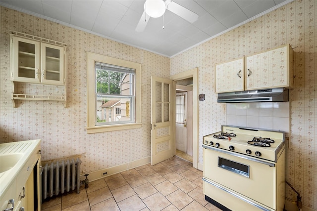 16 Oak Ter, Suffern, NY 10901 - kitchen featuring ornamental molding, under cabinet range hood, radiator, white gas range, and ceiling fan