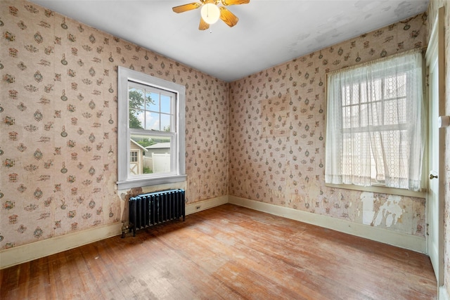 16 Oak Ter, Suffern, NY 10901 - spare room with radiator heating unit, light wood-style floors, wallpapered walls, baseboards, and ceiling fan