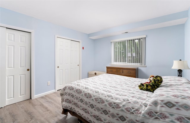 bedroom featuring wood finished floors and baseboards