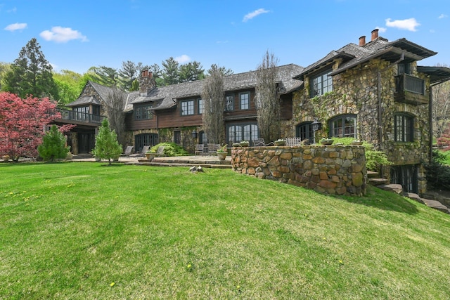 118 John St, Greenwich, CT 06831 - view of front facade with a chimney, stone siding, and a front yard