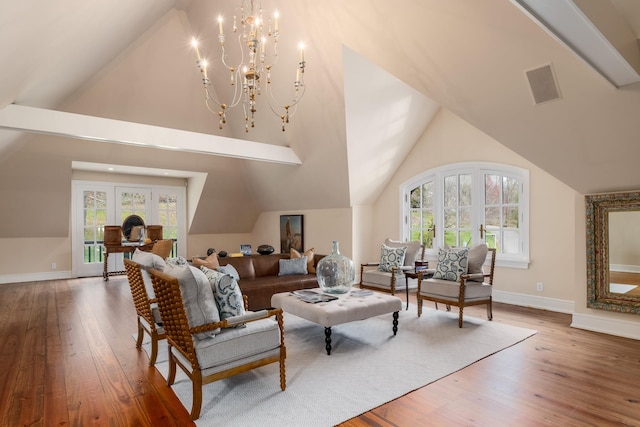 118 John St, Greenwich, CT 06831 - living area featuring wood-type flooring, baseboards, a chandelier, and high vaulted ceiling