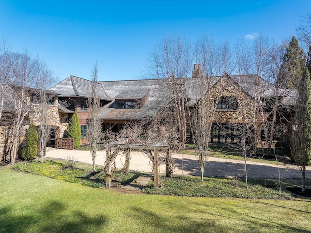 118 John St, Greenwich, CT 06831 - view of front of home with a chimney and a front yard