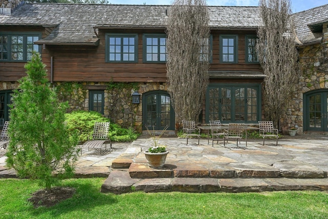 118 John St, Greenwich, CT 06831 - rear view of property with french doors, a patio area, and stone siding