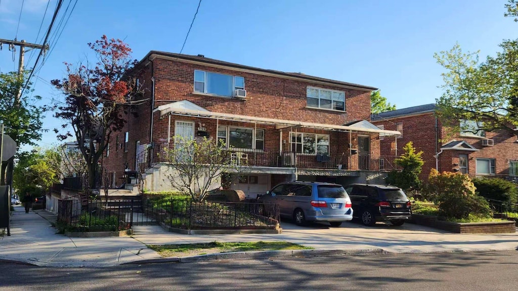 multi unit property with brick siding and driveway