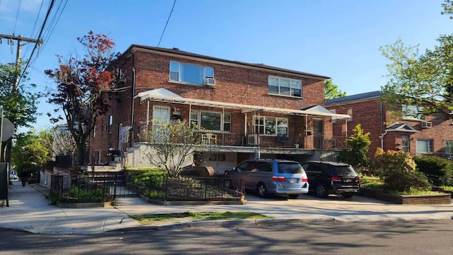 multi unit property with brick siding and driveway