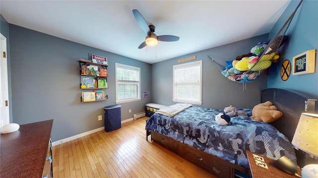 10 Courtney Ln, Brewster, NY 10509 - bedroom featuring a baseboard heating unit, wood-type flooring, baseboards, and a ceiling fan