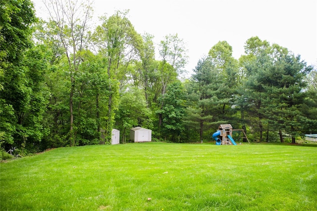 10 Courtney Ln, Brewster, NY 10509 - view of green lawn with a storage shed, a playground, and an outdoor structure