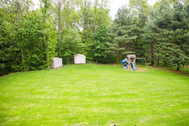 10 Courtney Ln, Brewster, NY 10509 - view of grassy yard featuring a shed, a playground, and an outdoor structure