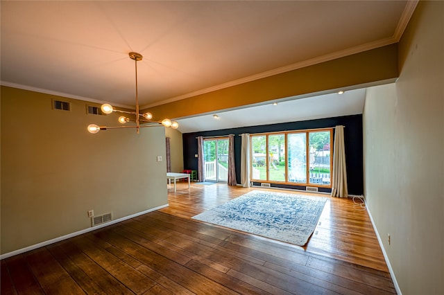 unfurnished room featuring wood-type flooring, a chandelier, baseboards, and crown molding