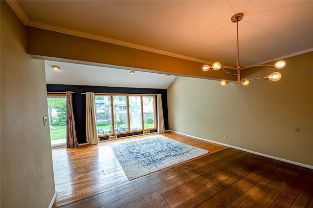 unfurnished room with a chandelier, hardwood / wood-style flooring, ornamental molding, and baseboards