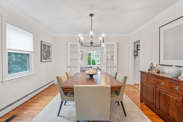 dining room featuring baseboard heating, a chandelier, light wood-style flooring, and ornamental molding