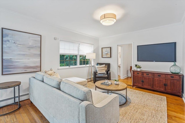 living room featuring ornamental molding, light wood-style flooring, and baseboard heating