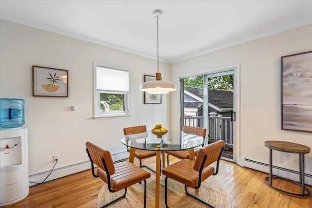 dining space with baseboard heating, light wood-style flooring, and ornamental molding