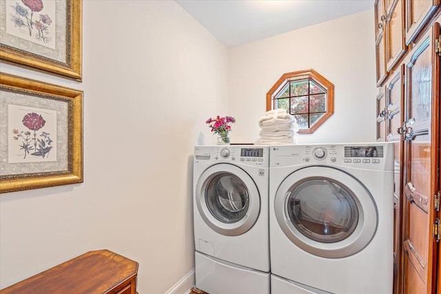 laundry room with washing machine and clothes dryer and baseboards