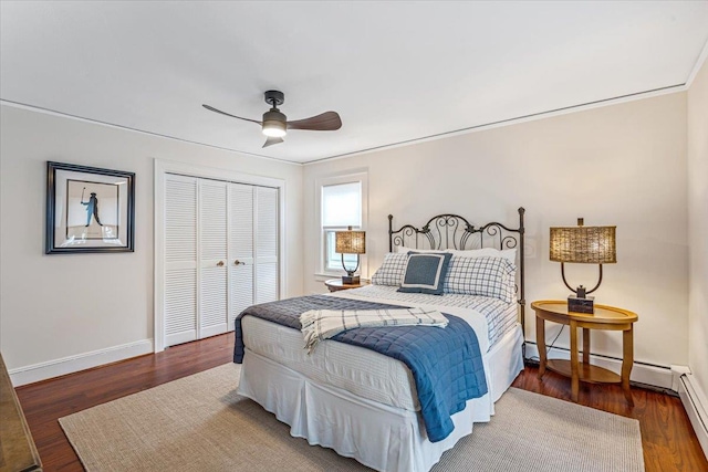 bedroom featuring baseboards, a closet, wood finished floors, and ceiling fan