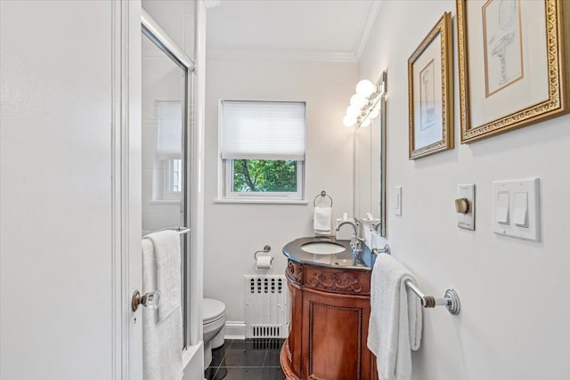 bathroom with radiator heating unit, crown molding, toilet, vanity, and a stall shower