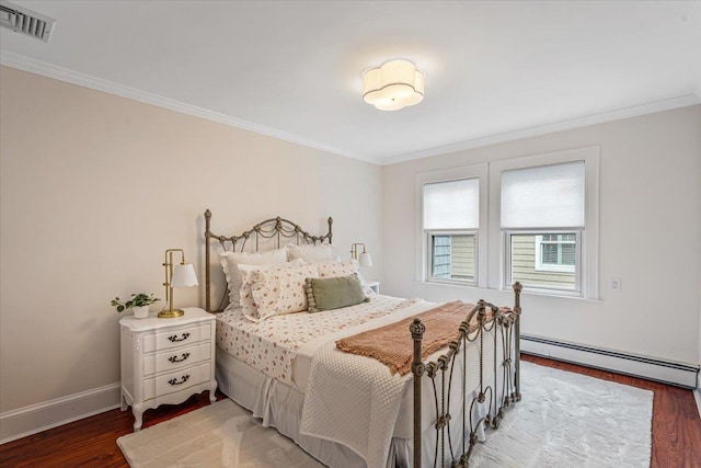 bedroom featuring a baseboard radiator, wood finished floors, crown molding, and baseboards