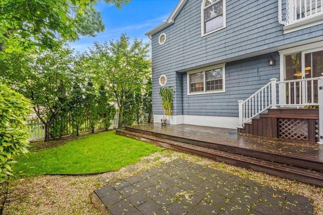 view of grassy yard featuring a patio and a deck