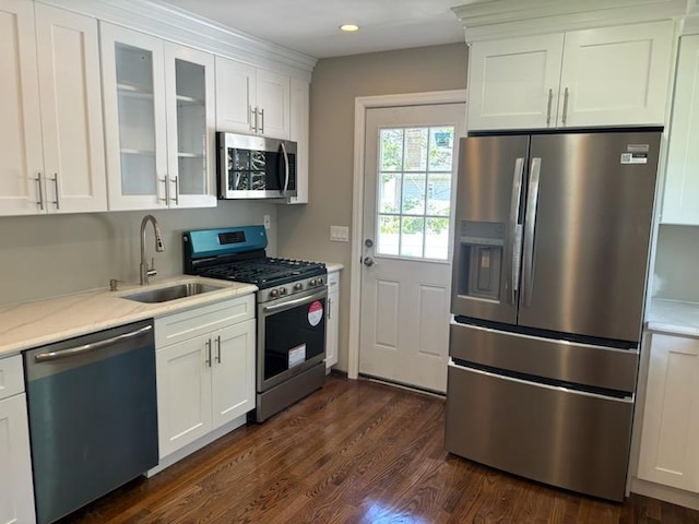 14 Chenango Dr, Bay Shore, NY 11706 - kitchen featuring appliances with stainless steel finishes, a sink, white cabinetry, glass insert cabinets, and dark wood-type flooring