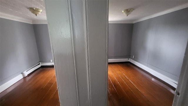164 Thompson St, Poughkeepsie, NY 12601 - spare room with ornamental molding, dark wood finished floors, a baseboard radiator, and baseboards
