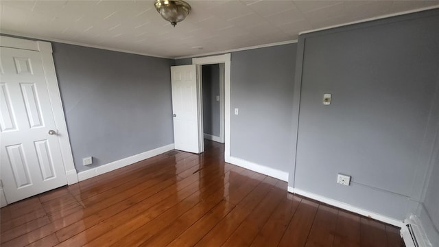 164 Thompson St, Poughkeepsie, NY 12601 - unfurnished bedroom with baseboard heating, baseboards, hardwood / wood-style flooring, and ornamental molding