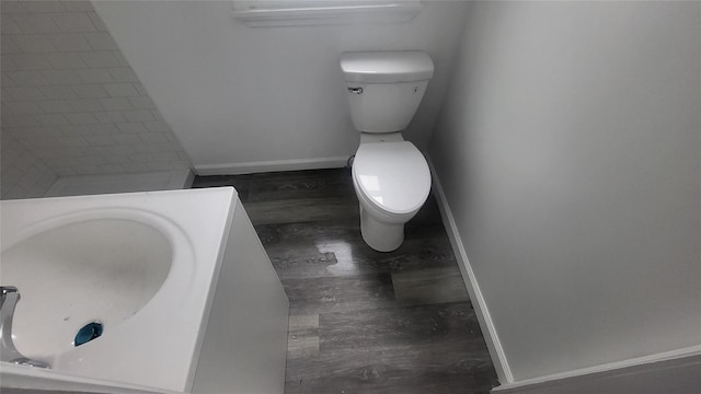 164 Thompson St, Poughkeepsie, NY 12601 - bathroom with toilet, wood finished floors, and baseboards