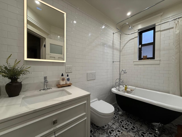 1821 Tenbroeck Ave, Bronx, NY 10461 - full bath featuring tile walls, toilet, a freestanding bath, vanity, and tile patterned floors