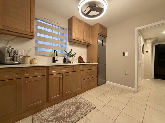 1821 Tenbroeck Ave, Bronx, NY 10461 - kitchen with built in fridge, a sink, light tile patterned flooring, and light countertops