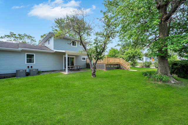 48 Hillside Ave, Patchogue, NY 11772 - view of green lawn featuring a wooden deck and stairs