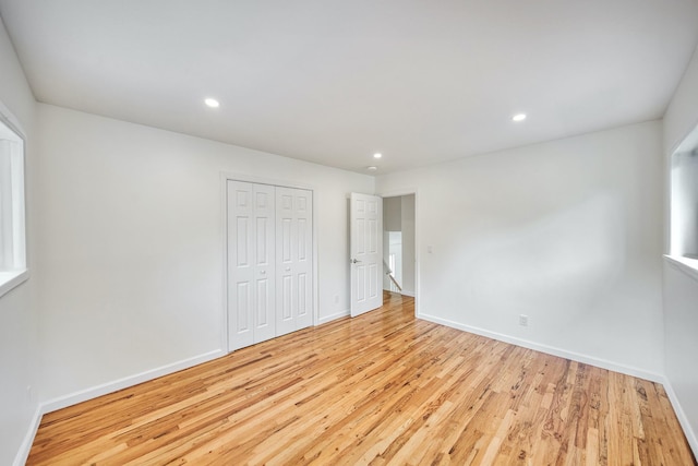 48 Hillside Ave, Patchogue, NY 11772 - unfurnished bedroom with light wood finished floors, a closet, baseboards, and recessed lighting