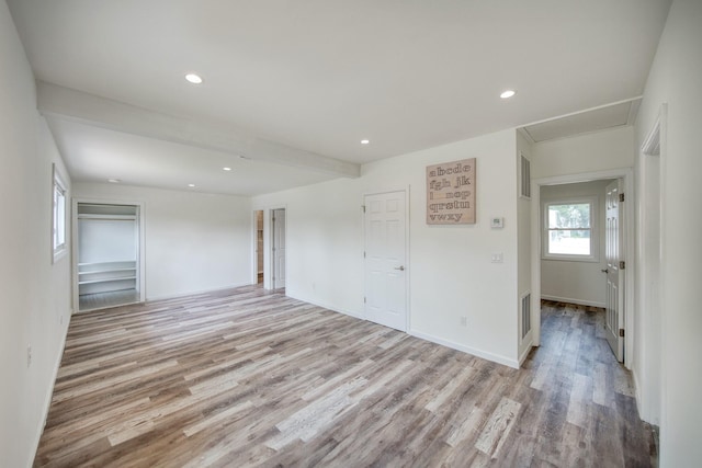 48 Hillside Ave, Patchogue, NY 11772 - empty room featuring light wood-style floors, recessed lighting, attic access, baseboards, and beam ceiling
