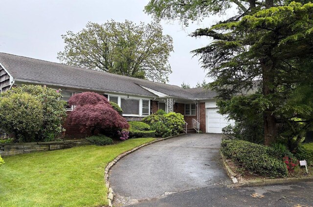 7 Ivy Ln, Lawrence, NY 11559 - single story home featuring a garage, asphalt driveway, a front lawn, and brick siding