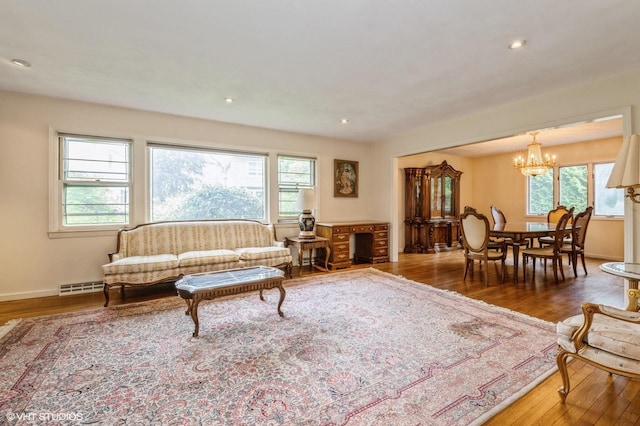 7 Ivy Ln, Lawrence, NY 11559 - living area with wood-type flooring, a chandelier, recessed lighting, and baseboards