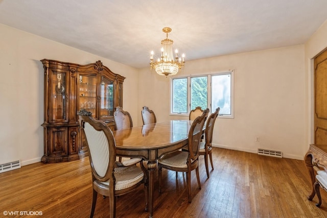7 Ivy Ln, Lawrence, NY 11559 - dining area featuring a chandelier, wood-type flooring, and baseboards