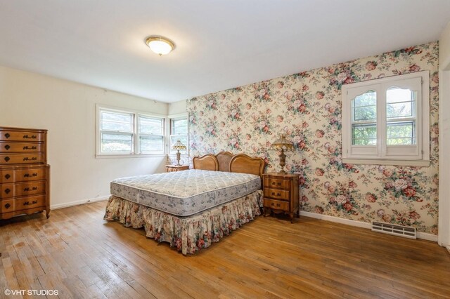7 Ivy Ln, Lawrence, NY 11559 - bedroom featuring hardwood / wood-style flooring, multiple windows, baseboards, and wallpapered walls