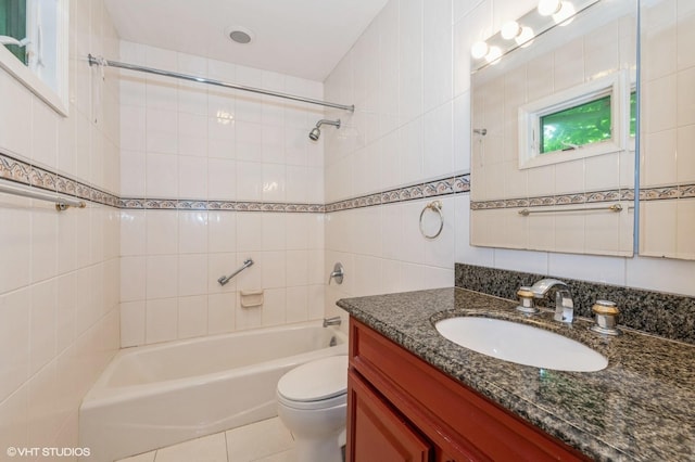 7 Ivy Ln, Lawrence, NY 11559 - bathroom with tile walls, vanity, washtub / shower combination, toilet, and tile patterned flooring