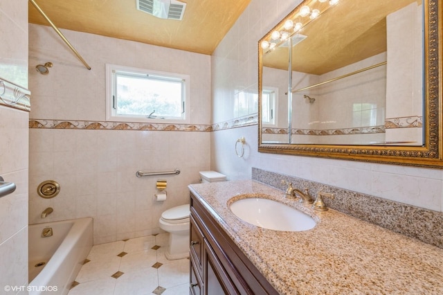 7 Ivy Ln, Lawrence, NY 11559 - full bathroom with tile walls, vanity, tile patterned flooring, toilet, and  shower combination