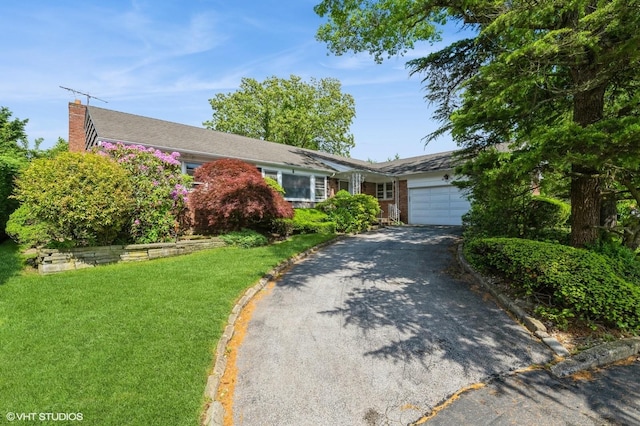 7 Ivy Ln, Lawrence, NY 11559 - single story home featuring an attached garage, driveway, a chimney, a front lawn, and brick siding