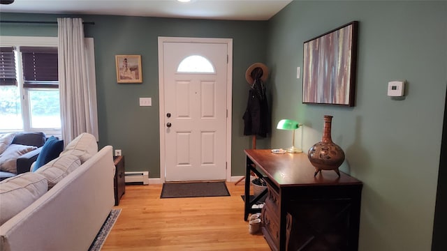 56 Church St, Wallkill, NY 12589 - foyer with baseboard heating, light wood-style floors, and baseboards