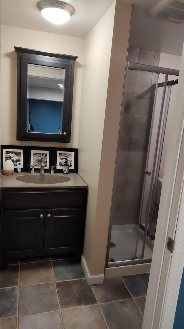 56 Church St, Wallkill, NY 12589 - full bath featuring a stall shower, vanity, baseboards, and tile patterned flooring
