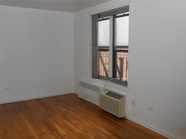 131-11KEWGARDENS Kew Gardens Rd Unit 4D, Richmond Hill, NY 11418 - empty room with radiator, plenty of natural light, wood finished floors, and baseboards